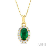 5x3 MM Oval Shape Emerald and 1/20 Ctw Round Cut Diamond Halo Precious Pendant with Chain in 10K Yellow Gold