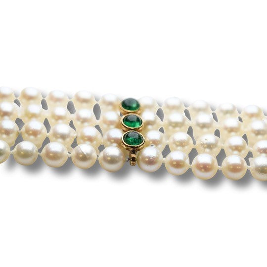 Four strand pearl bracelet with emerald and gold spacers
